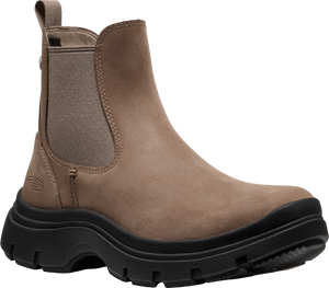 A pull-on light brown leather ankle boot with elastic side panels and thick black lug sole.
