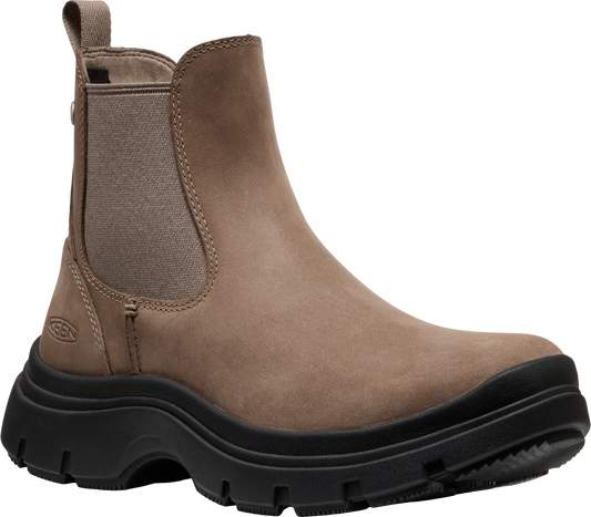 A pull-on light brown leather ankle boot with elastic side panels and thick black lug sole.