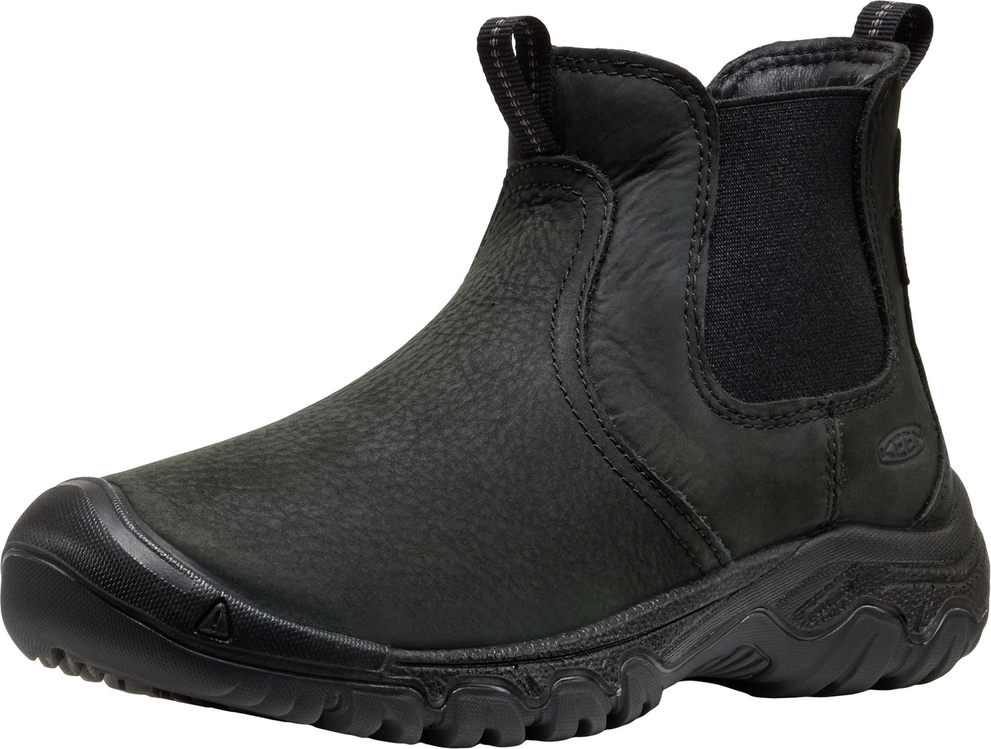 A black leather slip-on ankle boot with a rounded rubber toe cap, elastic side panels, and a chunky, textured black rubber sole.
