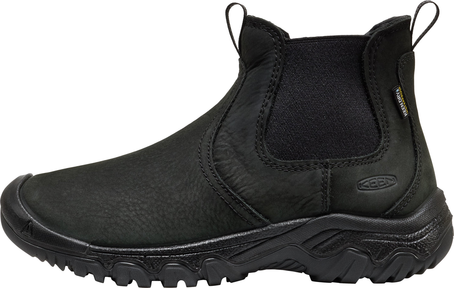 A black leather slip-on ankle boot with a rounded reinforced toe cap, elastic side gussets, a pull tab at the back, and a rugged, thick rubber treaded sole, with the word KEEN embossed on the side and a small tag on the collar.