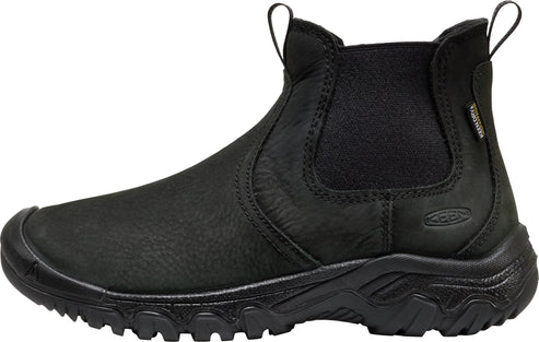 A black leather slip-on ankle boot with a rounded reinforced toe cap, elastic side gussets, a pull tab at the back, and a rugged, thick rubber treaded sole, with the word KEEN embossed on the side and a small tag on the collar.