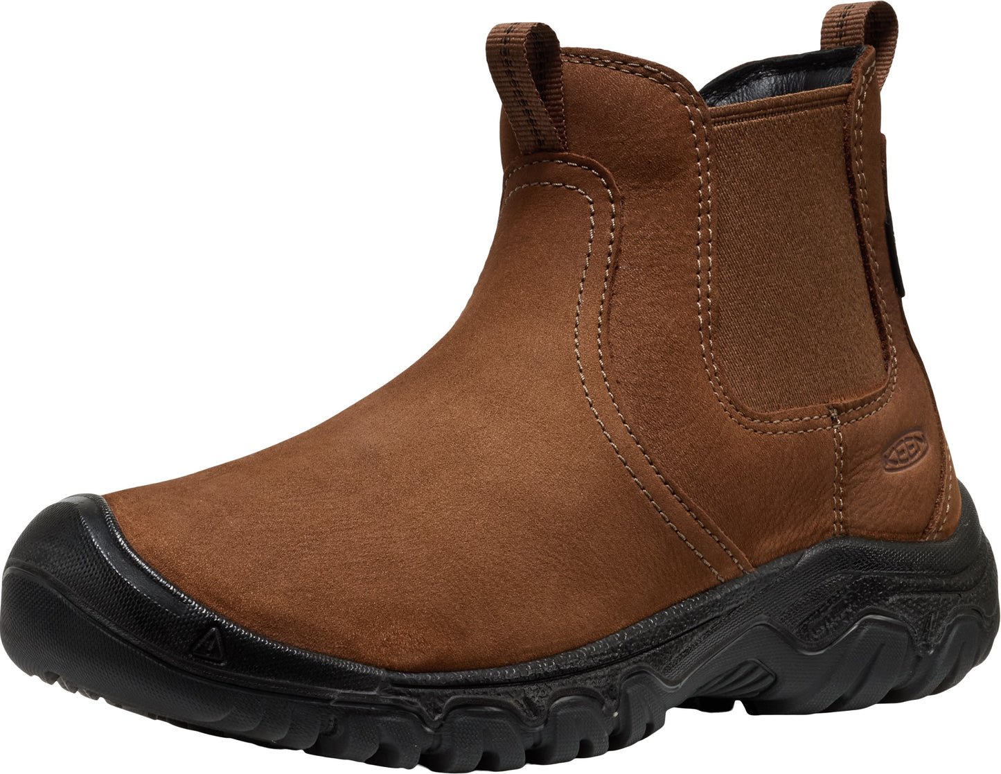 A brown suede Chelsea-style boot with a rugged, black rubber lug sole and a reinforced toe bumper, featuring elastic side panels and pull tabs on the front and back of the collar.