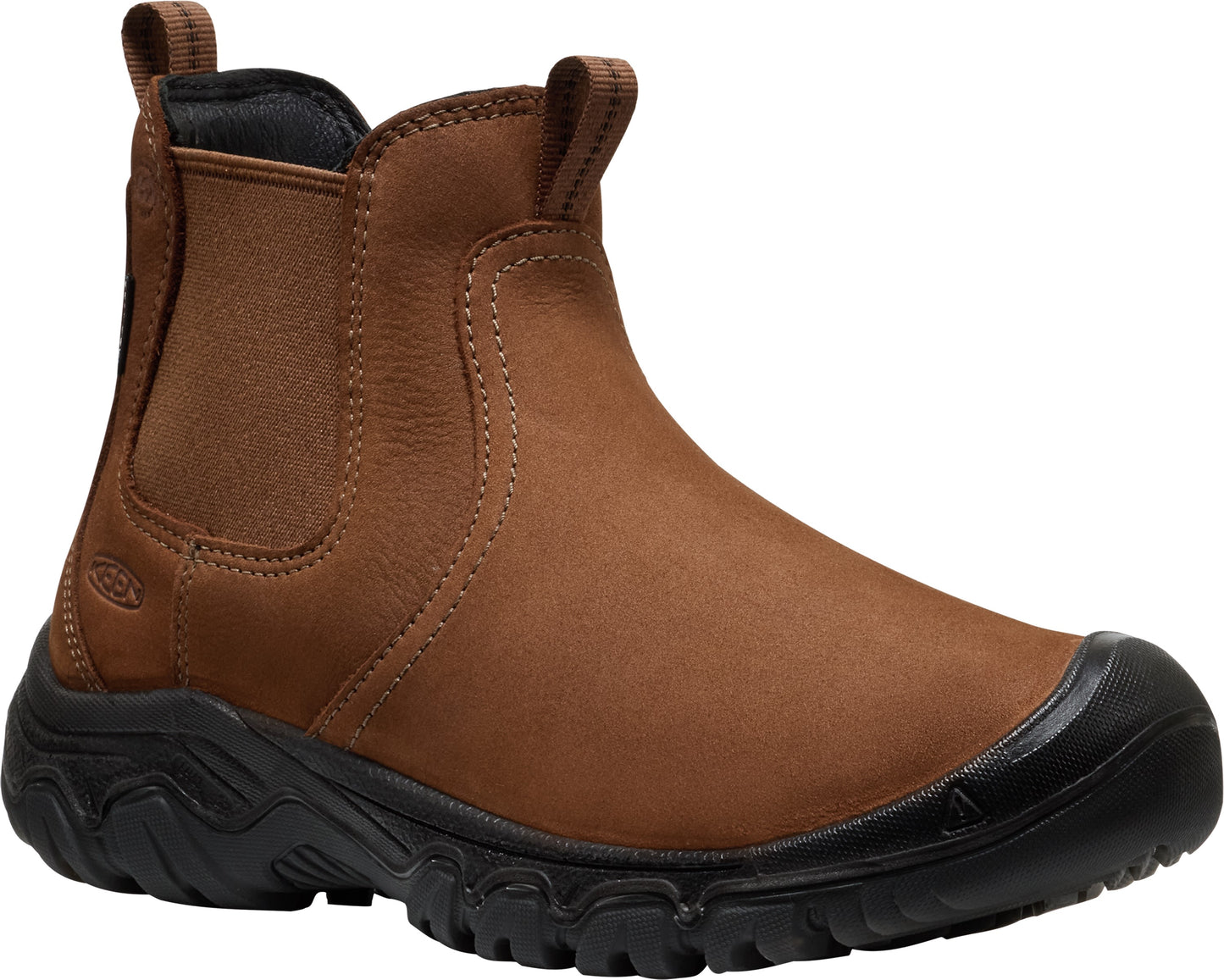 A brown leather Chelsea boot with a black rubber lug sole and a reinforced black toe cap.