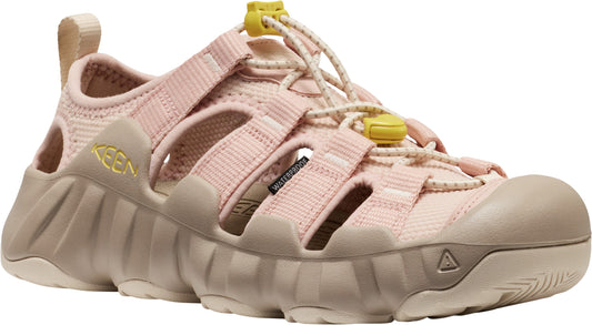 Pink sandal with adjustable elastic cords, beige toe bumper, and chunky lug sole.