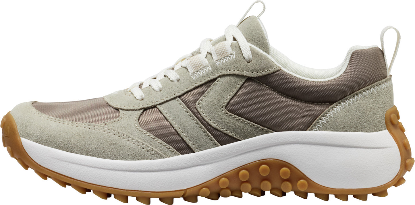 A sneaker with a beige, gray, and brown upper, white midsole, and brown lug outsole.