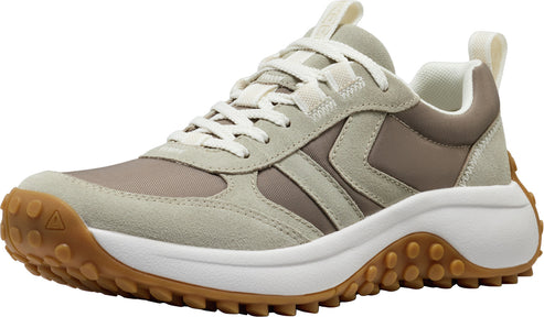 Low-profile beige sneaker with white laces, white midsole, and brown lug outsole.