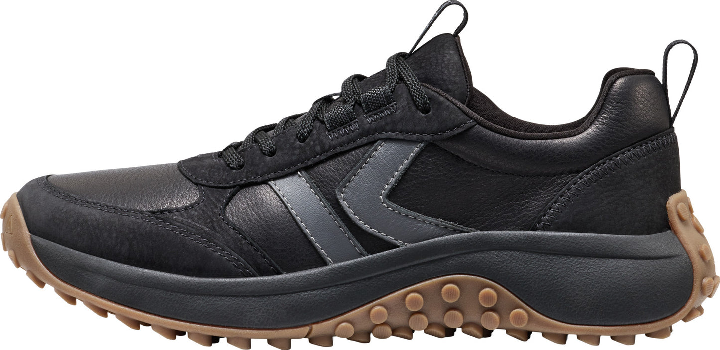 A black sneaker with a brown sole.