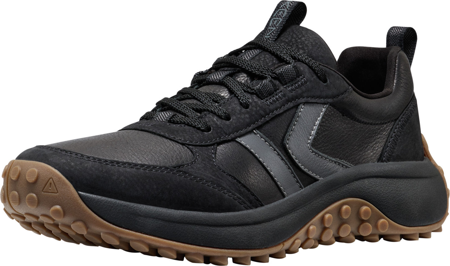 Black low-top sneaker with lug sole.