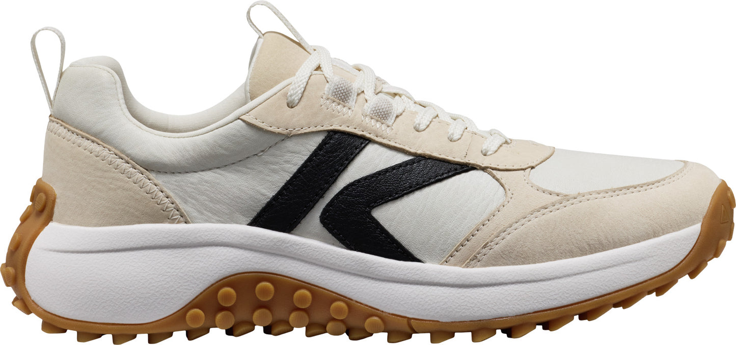 A white and black sneaker with a brown rubber sole.