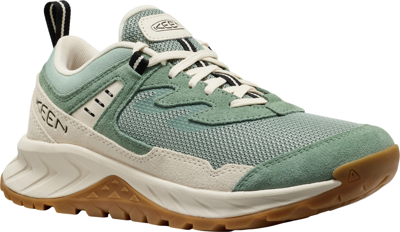 A low cut hiking shoe featuring a mesh upper with suede accents, a thick white midsole, and a brown lugged outsole.