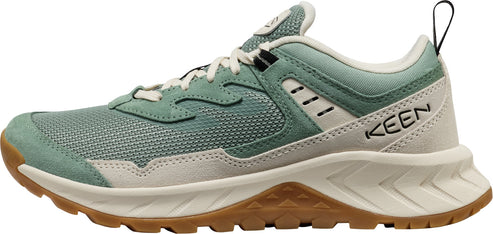 A KEEN brand athletic shoe with a light green body and brown sole.