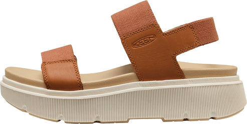 Side view of a tan sandal with a thick, off-white platform sole and two elastic straps.