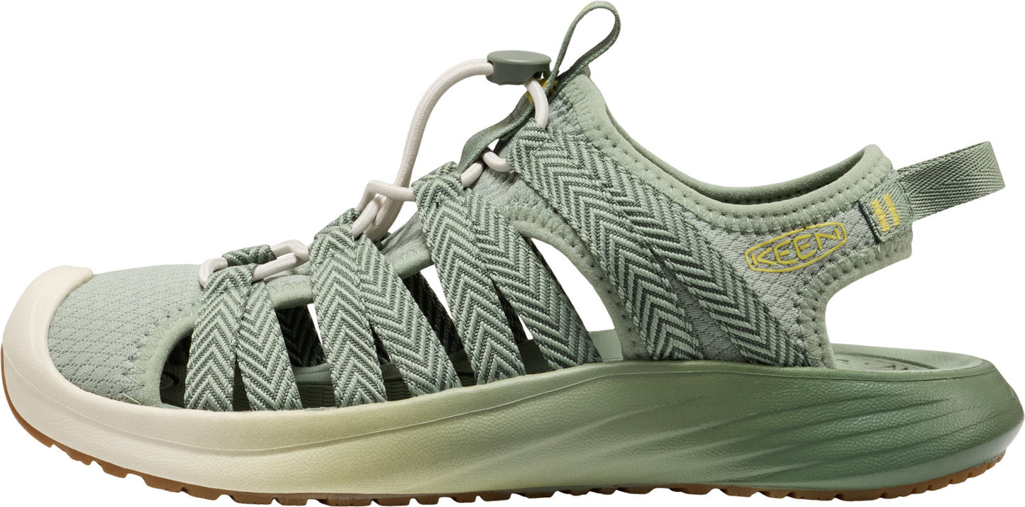 A sage green sandal with a beige sole.