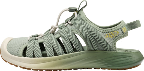 A sage green sandal with a beige sole.