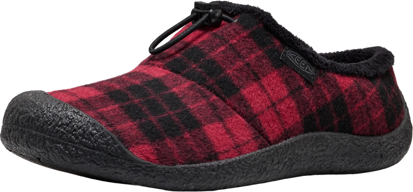 A slip-on shoe featuring a red and black plaid felt upper, a black rubber toe cap, a thick black textured rubber sole, and a black cord lock lacing system on the top, with a dark fuzzy interior lining and a small Keen tag on the side.