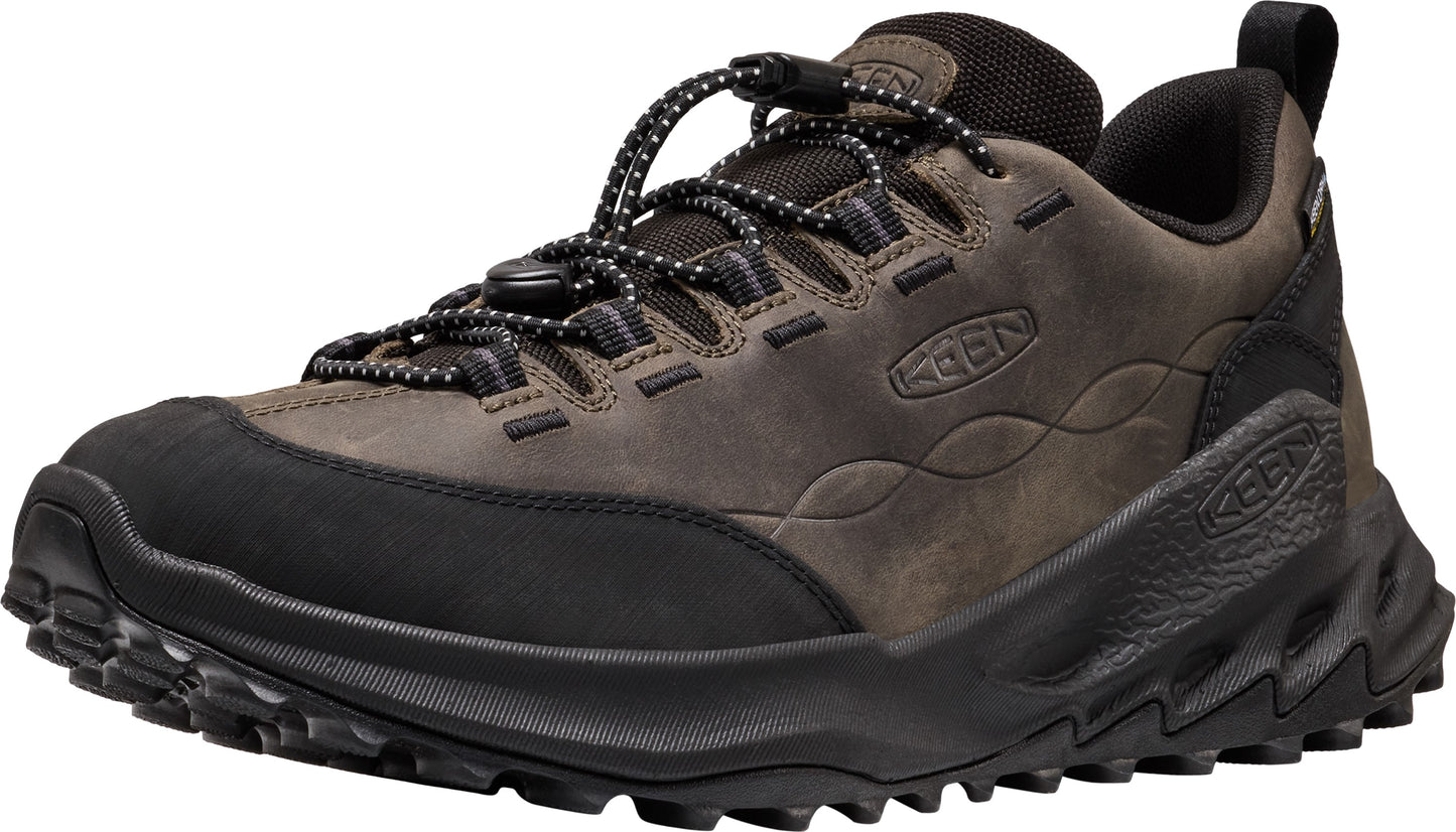 A brown leather hiking sneaker with a black rubber toe cap, black zigzag patterned midsole, and a black lace-up closure with a toggle.