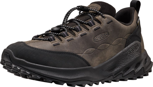 A brown leather hiking sneaker with a black rubber toe cap, black zigzag patterned midsole, and a black lace-up closure with a toggle.
