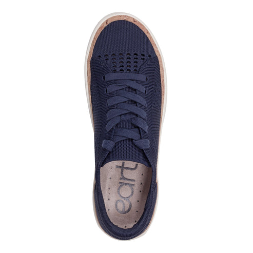 Top-down view of a navy blue knit sneaker with cork trim and 'earth' printed on the insole.