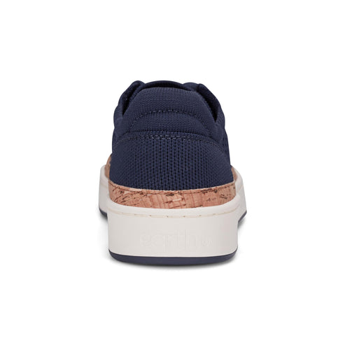 Rear view of a navy blue sneaker with a cork accent and a white sole.