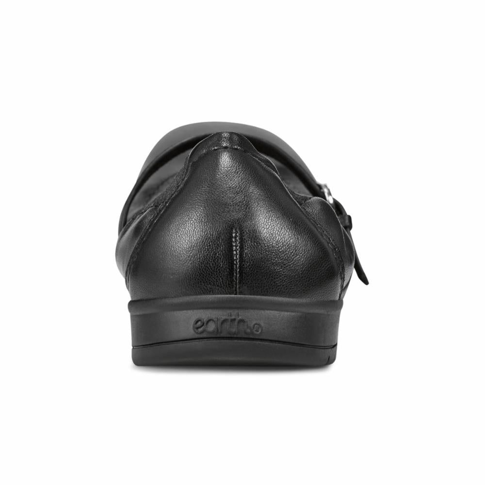 Black leather Mary Jane shoe rear view showing "earth" logo.