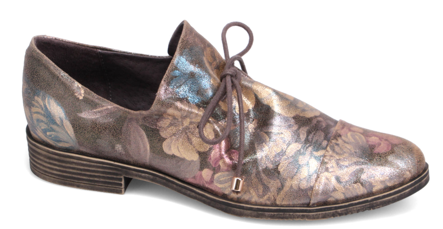Floral patterned oxford shoe with lace up closure and low heel.
