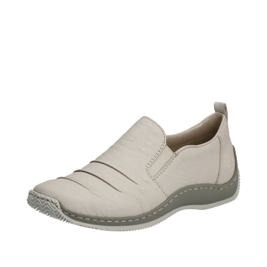 Beige slip-on shoe with a low gray sole.
