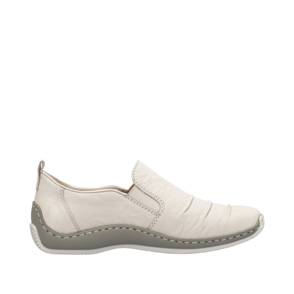 Beige slip-on shoe with a gray sole.
