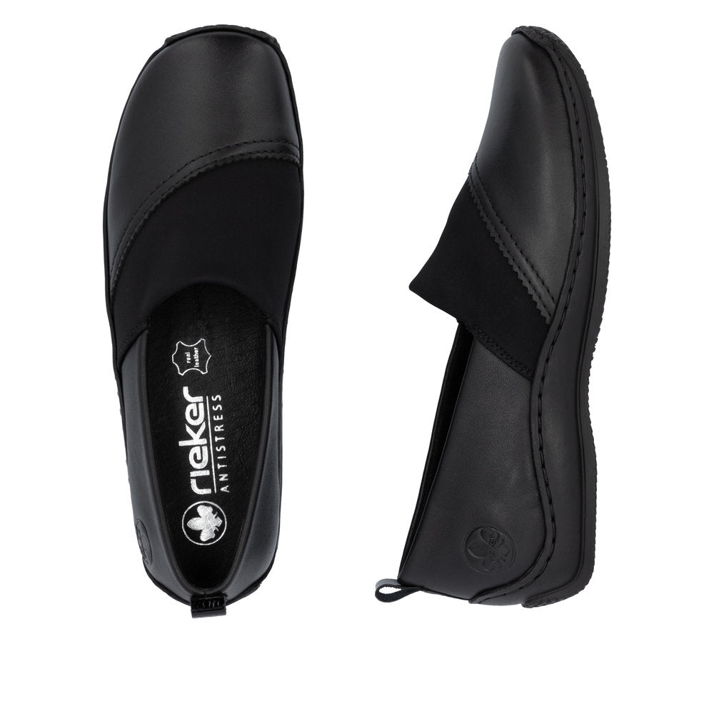 Two identical black leather flats viewed from above and side featuring a thick, black elastic panel at the instep, and a Rieker Antistress insole.