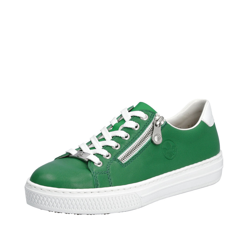 A green sneaker with white laces, a silver zipper, and a white sole.