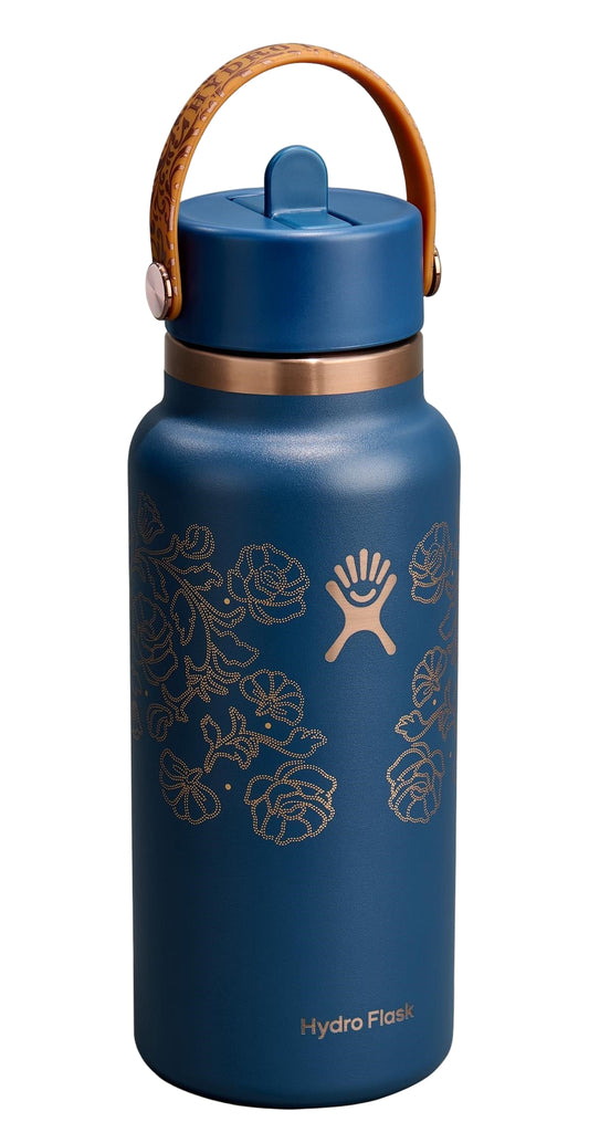 Blue water bottle with golden decorative floral design, handle, and straw.