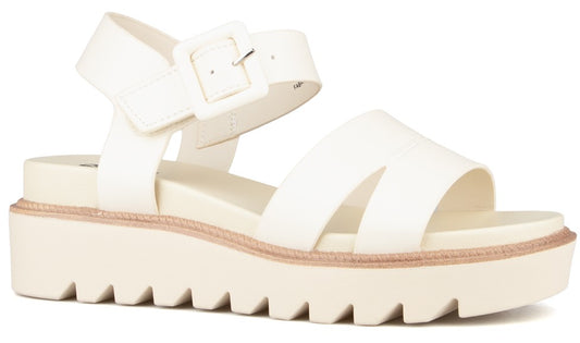 White platform sandal with thick straps and buckle closure.