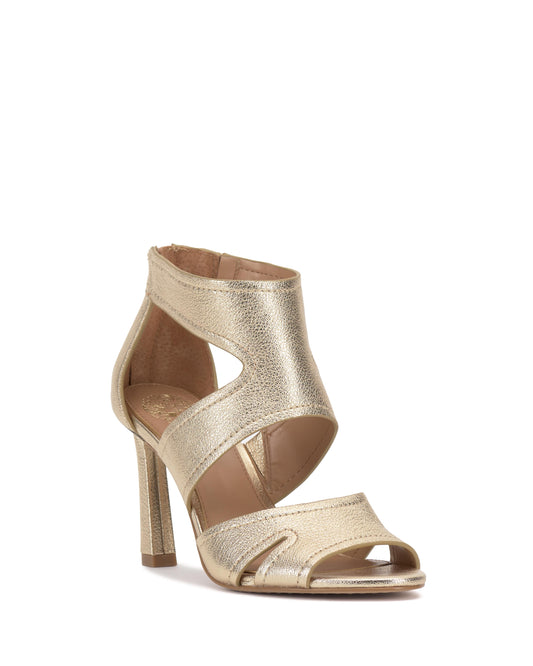 Gold-colored high-heeled sandal with cutouts.