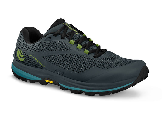 Gray running shoe with a black sole and laces, green accents, and visible 'Vibram' logo.