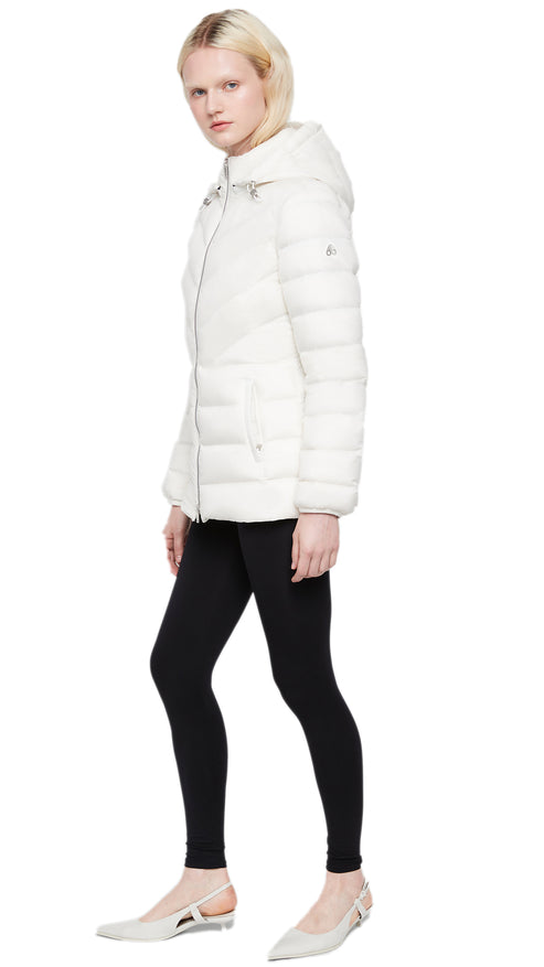 A person wearing a white quilted hooded jacket over black leggings, and flats.