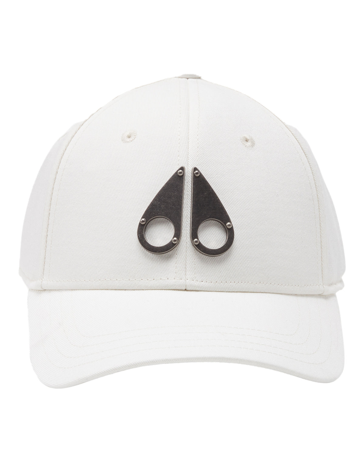 White baseball cap with two metal teardrop shapes with circles and rivets.