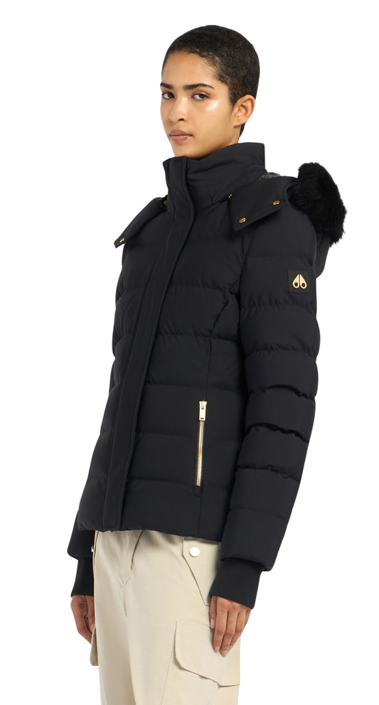 A black puffer jacket with gold zippers and a fur-trimmed hood on a person.