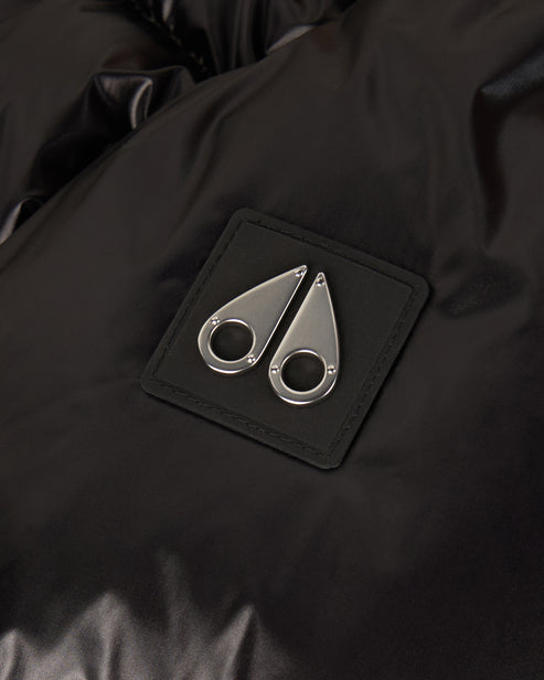 Close-up of a black square patch with a silver, double teardrop logo.
