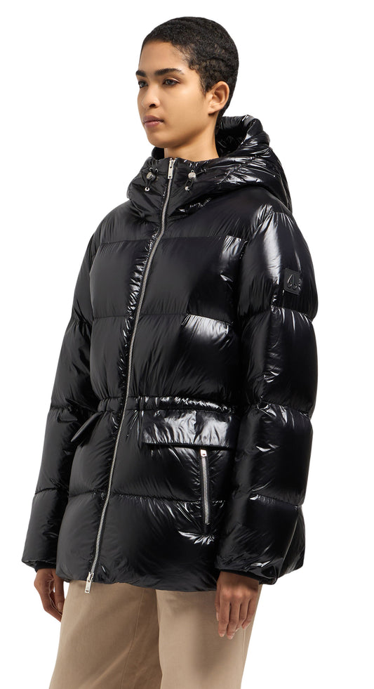 A woman wearing a black shiny, puffed-down jacket with a hood and pockets.