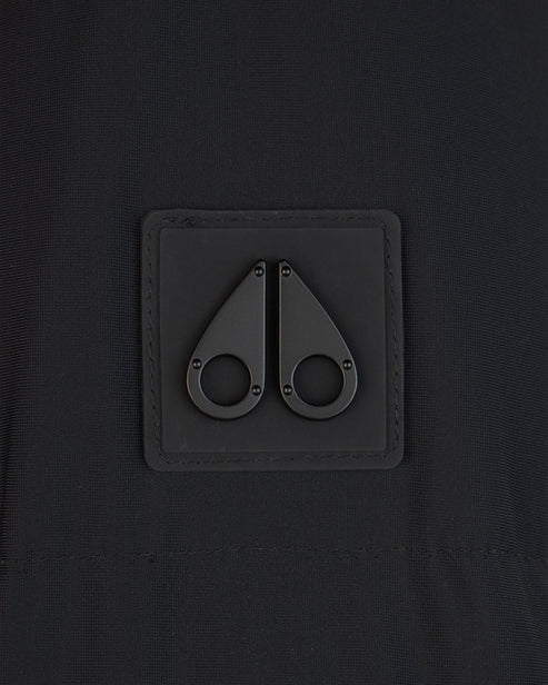 Close-up of a black fabric square with two black metal fastener details.