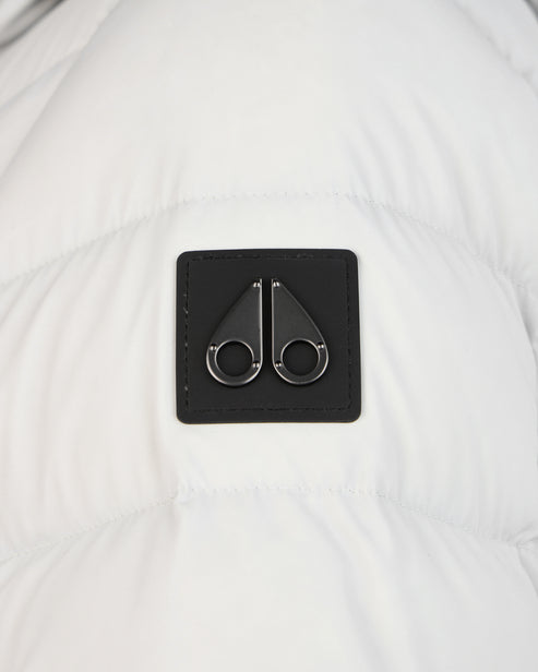 Close-up of a black, square-shaped logo with two metallic rings attached to the top and bottom.