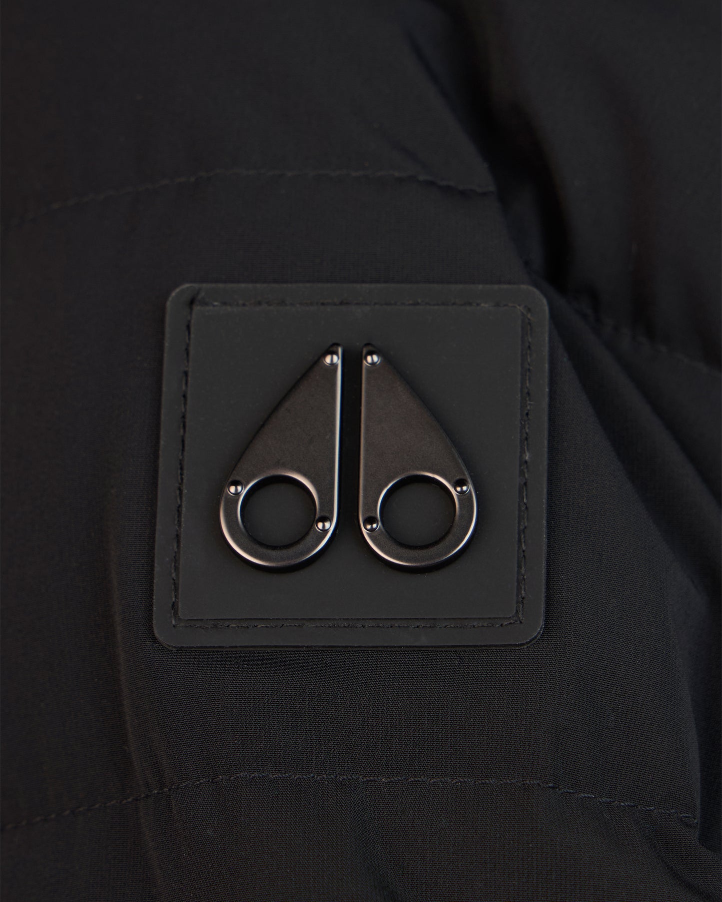 Black patch with two metallic moose knuckle symbols.