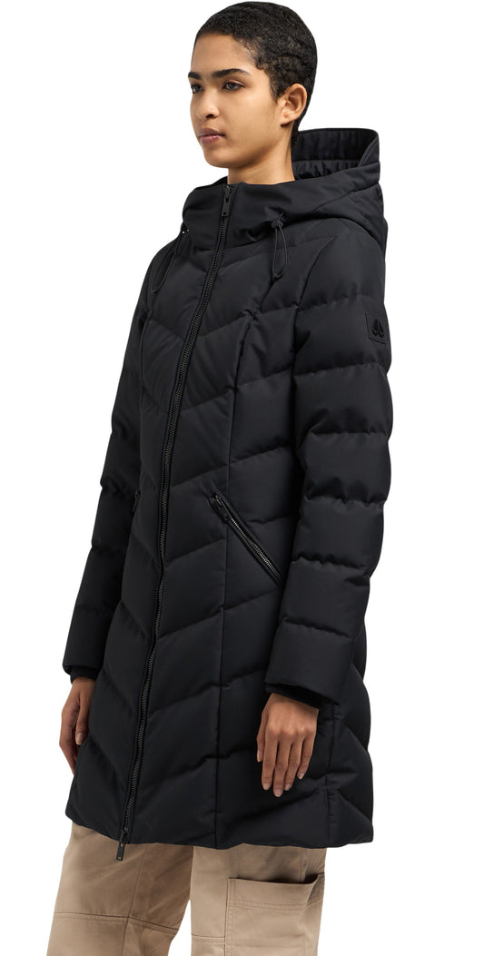 A woman is wearing a black puffer coat with a hood.