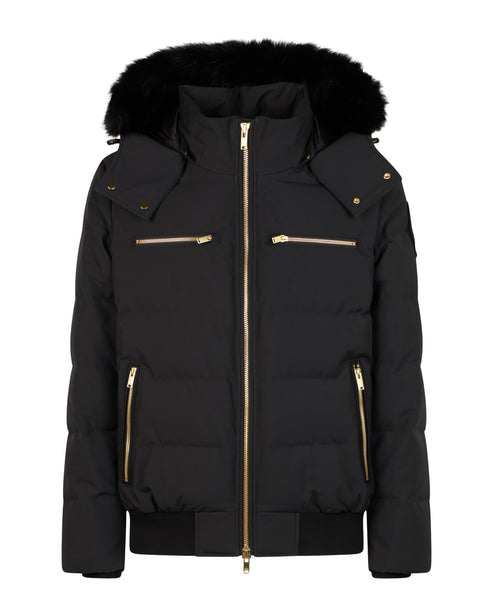 Black puffer jacket with fur-trimmed hood and gold zippers.