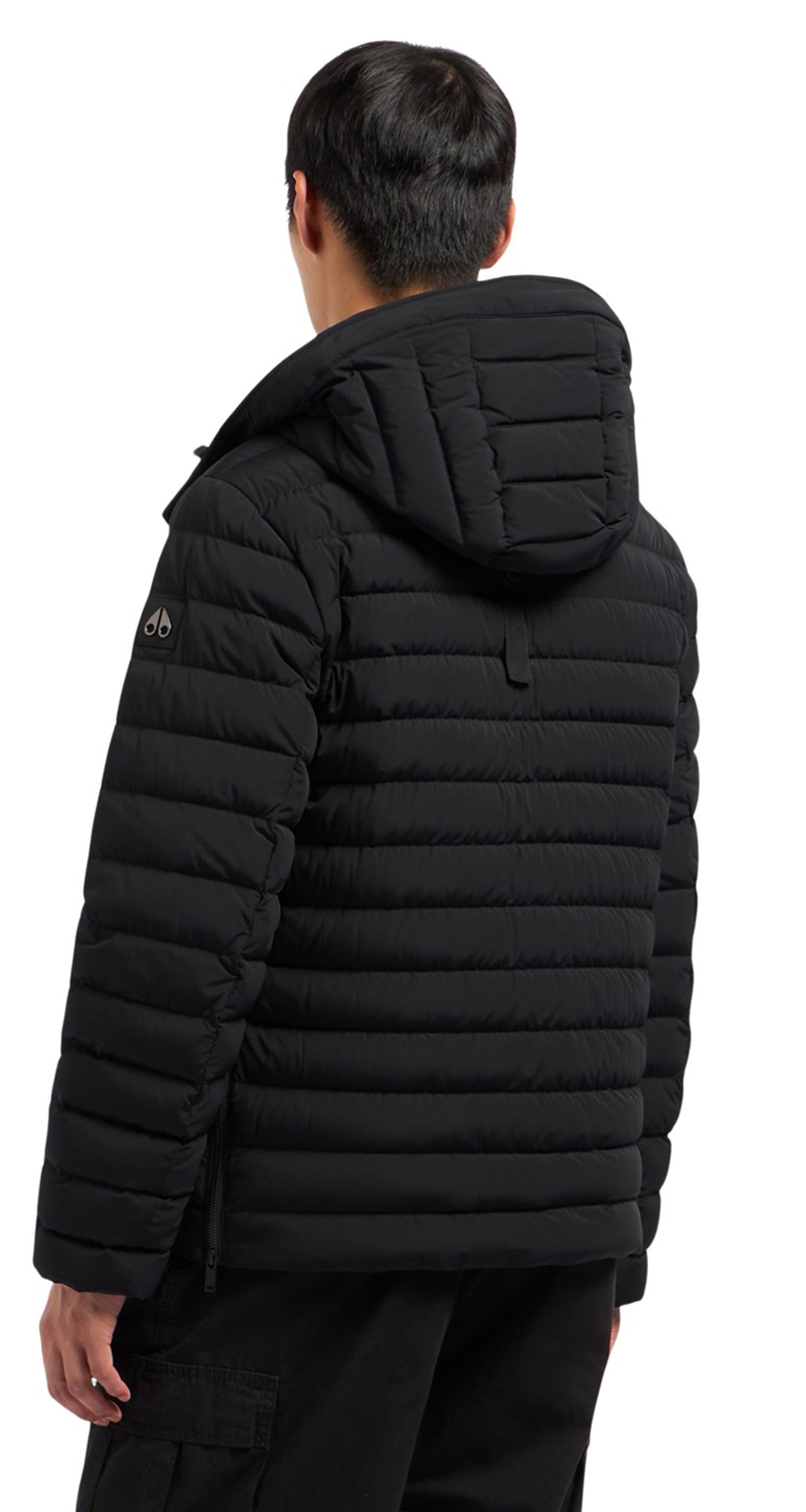 Back view of a quilted black hooded jacket on a person.