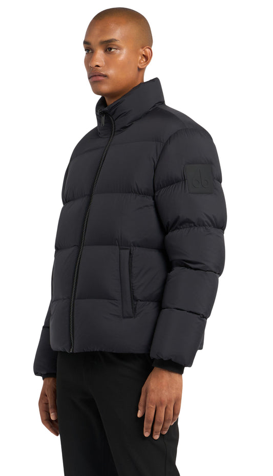 A man in a black puffer jacket and black pants.