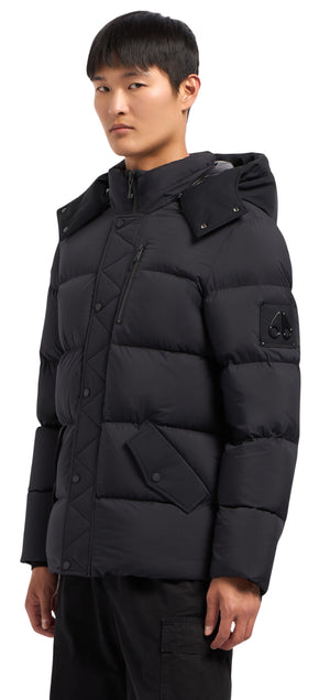 A man wears a black puffer jacket with a hood.