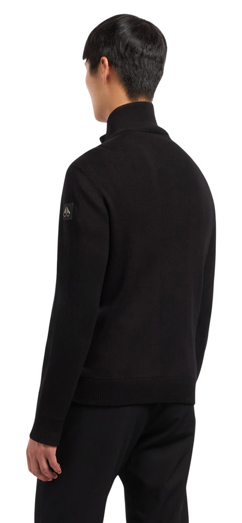 A black long-sleeve collared sweater.