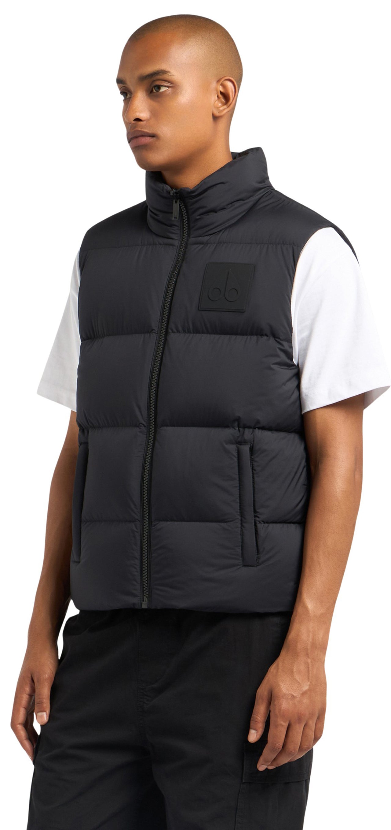 A man wearing a sleeveless black puffy vest.