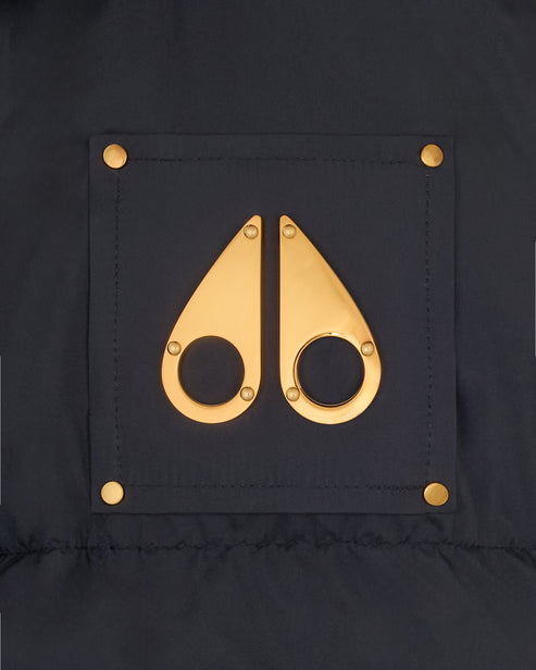 Gold metallic moose knuckle logo on dark fabric.