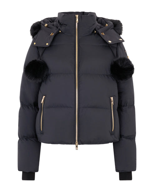 Black puffer jacket with fur hood trim and fur pompoms on sleeves.